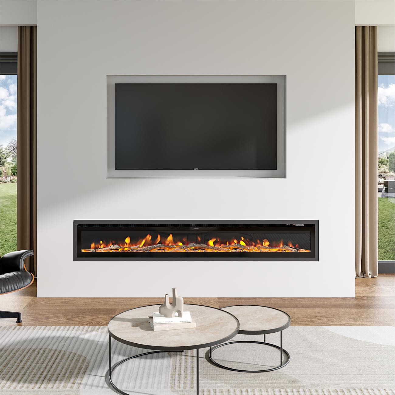 Large recessed electric fireplace with glowing orange flames, seamlessly integrated into a minimalist white wall below a built-in TV, paired with a modern round coffee table and natural light from large windows.